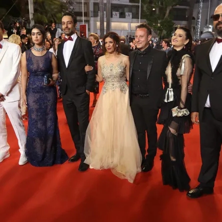 (FromL) French-Tunisian producer Nadim Cheikhrouha, Tunisian director Kaouther Ben Hania (C), Tunisian actress Mariam Al Ferjani (2ndL), Tunisian actor Ghanem Zrelli (3rdL), producer Mohamed Habib Attia (3rdR), French-Tunisian actress Anissa Daoud (2ndR) and Tunisian actor Chedly Arfaoui (R) pose as they arrive on May 19, 2017 for the screening of the film 'Beauty and the Dogs' (Aala Kaf Ifrit) at the 70th edition of the Cannes Film Festival in Cannes, southern France. (Photo by Valery HACHE / AFP)