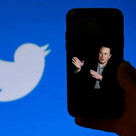 Elon Musk with the Old Twitter logo. OLIVIER DOULIERY / AFP
