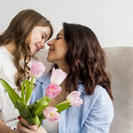 صورة لطفلة تقدم الورود لأمها