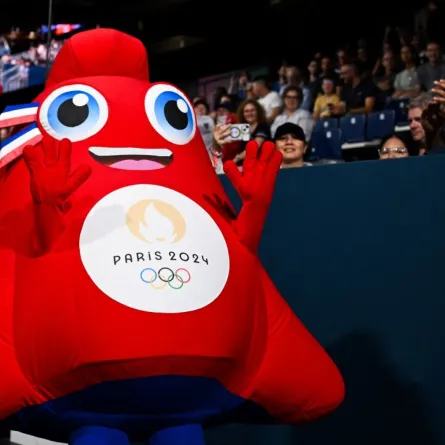 Olympic Phryge, the official mascot of the Paris 2024 Olympic Games greets members of the public prior to the start of the men and women's table tennis singles preliminary rounds at the Paris 2024 Olympic Games at the South Paris Arena in Paris on July 27, 2024. (Photo by JUNG Yeon-je / AFP)