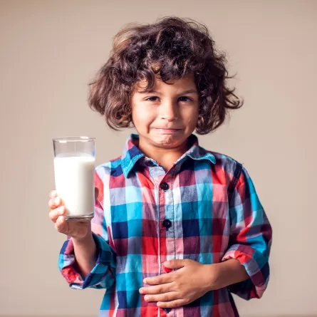 صورة لطفل يحمل كوباً من الحليب