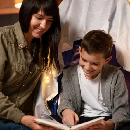 صورة لأم تحكي قصة لطفلها