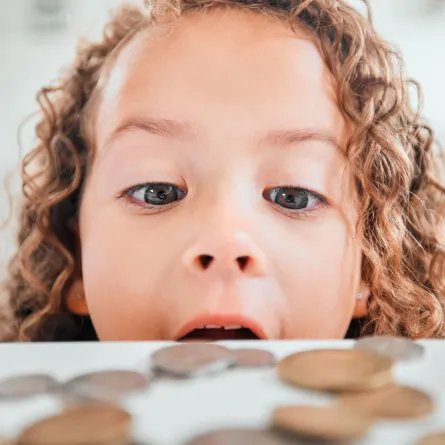 صورة طفلة تنظر إلى النقود