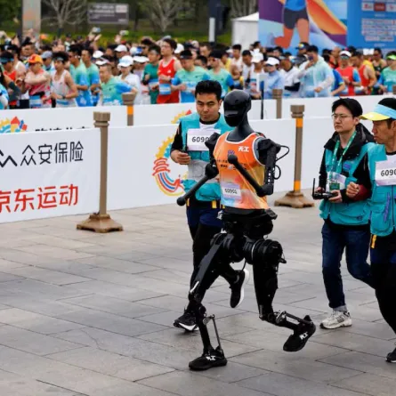 Humanoid robot "Tiangong" participates along with human runners in the E-Town Half Marathon & Humanoid Robot Half Marathon in Beijing, China April, 19 2025. REUTERS/Tingshu Wang