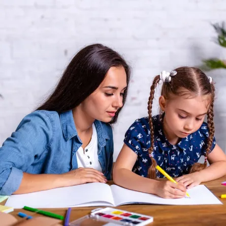 صورة لأم تدعم طفلتها في المذاكرة