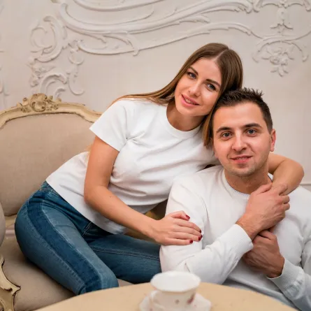 زوجة تضع رأسها على رأس زوجها وهو يمسك بيدها   