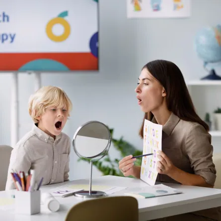 صورة لطفل لديه تأخر في النطق مع أخصائية نطق