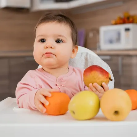 صورة رضيع يمسك بالفاكهة