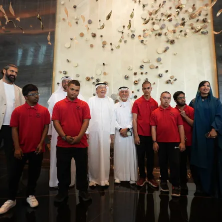 صورة جماعية للحضور مع طلاب مركز راشد