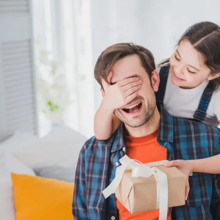 صورة لطفلة تقدم هدية لأبيها