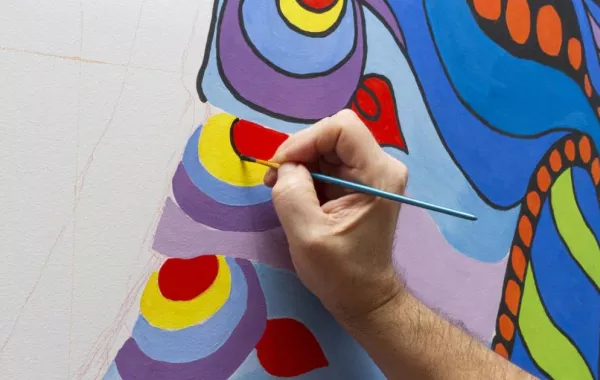 فنان سعودي يبدع في رسم لوحاته على الرصيف