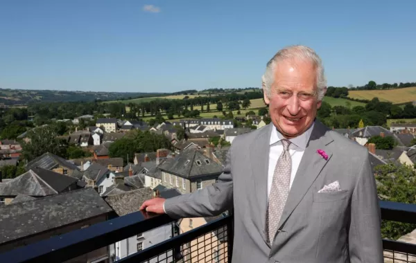 Britain's Prince Charles, Prince of Wales poses for a photograph at the viewing platform during a visit to Hay Castle, in Hay-on-Wye, Wales, on July 7, 2022. This summer, Hay Castle opens its doors to the public for the first time in its 900-year history, following a major restoration project creating an important new heritage destination, a vibrant new centre for learning and the arts, and a space for the community to come together.Chris Jackson / POOL / AFP