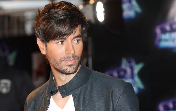Spanish singer Enrique Iglesias poses upon his arrival at the Palais des Festivals to attend the 18th Annual NRJ Music Awards on November 12, 2016 in Cannes, southeastern France. VALERY HACHE / AFP