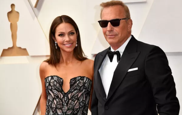 Kevin Costner(R) and his wife Christine Baumgartner attend the 94th Oscars at the Dolby Theatre in Hollywood, California on March 27, 2022. ANGELA WEISS / AFP