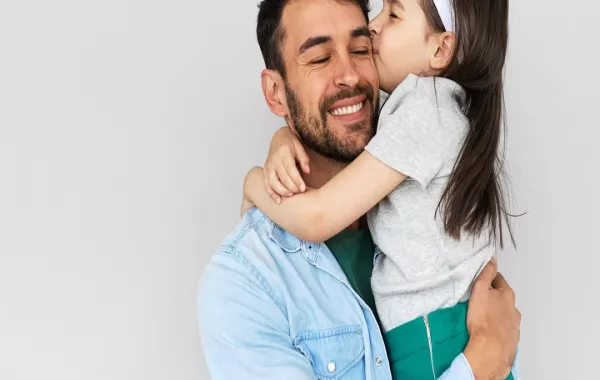 صورة لطفلة تقبل أباها