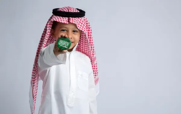 طفل يحتفي باليوم الوطني السعودي
