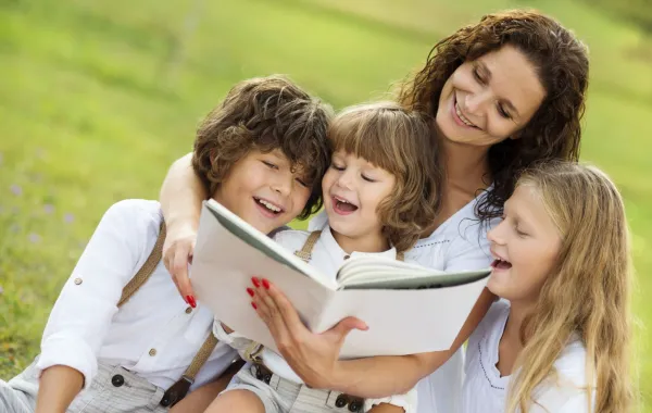 صورة الأم تقرأ القصص لأطفالها