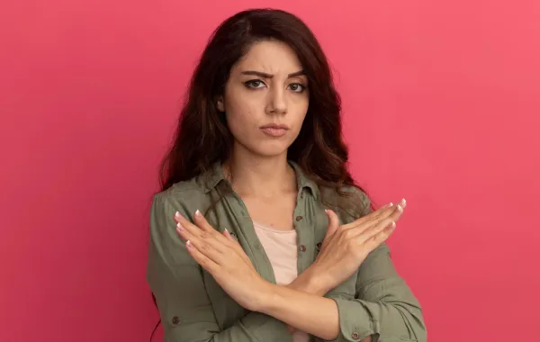 فتاة تشير بيديها علامة الرفض فهي تضع لنفسها حدوداً وتتعامل بحزم مع مختلف الشخصيات - المصدر: freepik by stockking