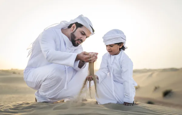 أب يغرس لدى طفله مفاهيم حب الوطن وانتمائه إليه في عمر مبكر