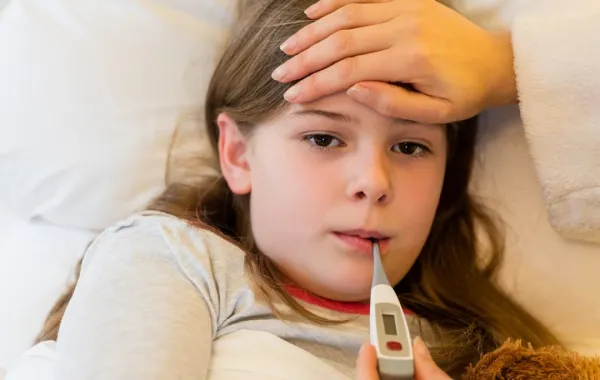 أم تقيس حرارة طفلتها