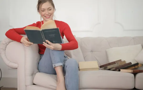 شابة تقرأ كتابا باستمتاع