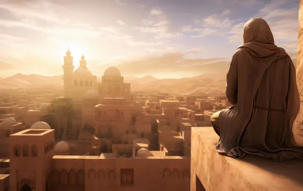 رجل يجلس على ربوة يشاهد قريته من عل