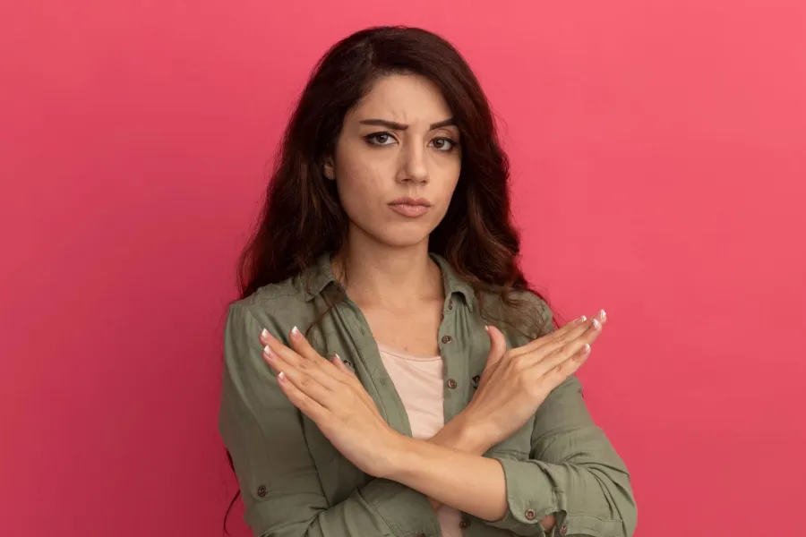 فتاة تشير بيديها علامة الرفض فهي تضع لنفسها حدوداً وتتعامل بحزم مع مختلف الشخصيات - المصدر: freepik by stockking فتاة تشير بيديها علامة الرفض فهي تضع لنفسها حدوداً وتتعامل بحزم مع مختلف الشخصيات - المصدر: freepik by stockking